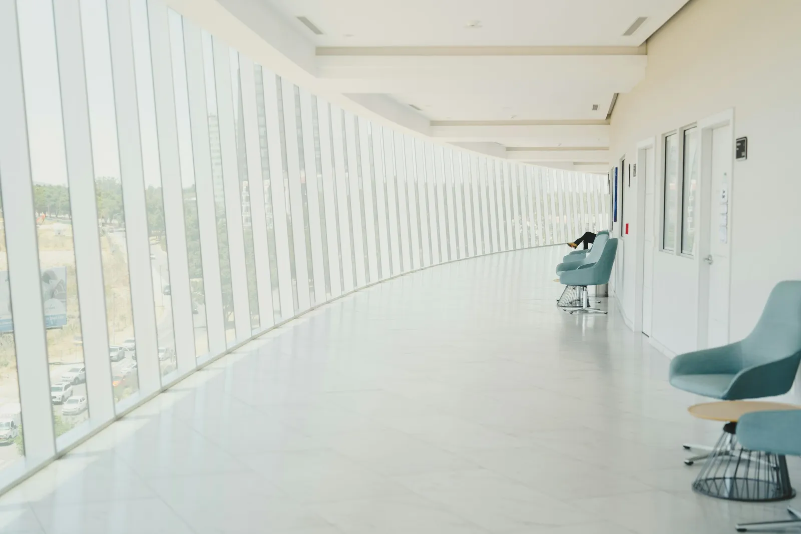 A long, bright corridor inside a modern hospital